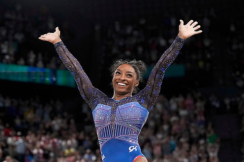Simone Biles celebrates after performing in the floor exercise
